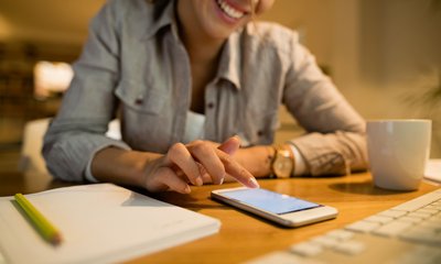 closeup-happy-woman-using-mobile-phone-text-messaging-night-home (1)